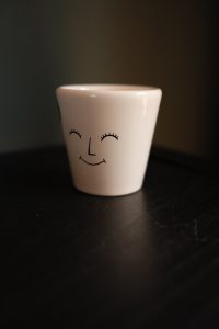7cm Ivyline glazed ceramic pot with characterful face design in soft neutral tones